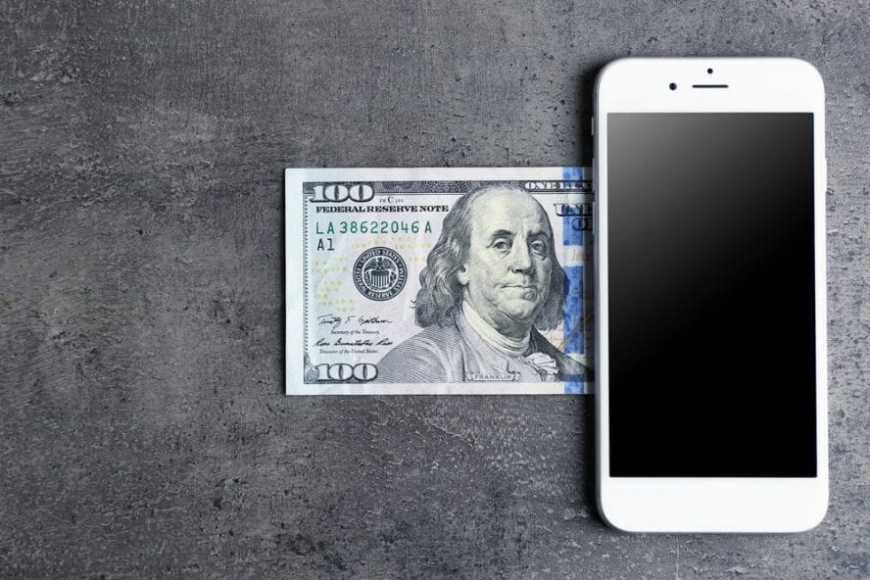 mobile phone money on grey background