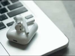 Apple Airpods Sitting On Top Of A Macbook