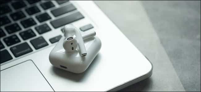 Apple Airpods Sitting On Top Of A Macbook