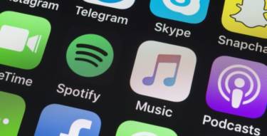 spotify, apple music, podcasts and other phone apps on iphone screen